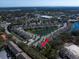 An aerial view showing townhomes near a serene lake, and lush green landscape at 1986 Lake Ridge Blvd, Clearwater, FL 33763