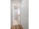 Hallway view of bathroom featuring a double door linen closet, sink with granite counter and toilet at 1986 Lake Ridge Blvd, Clearwater, FL 33763