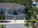 Front exterior view of townhome with a two-car garage and well-maintained landscaping at 1986 Lake Ridge Blvd, Clearwater, FL 33763