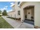 Inviting front entrance with a covered porch, well-maintained landscaping, and a walkway, creating a warm welcome at 1986 Lake Ridge Blvd, Clearwater, FL 33763