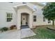 Charming front entrance features a covered porch, tidy landscaping, and a walkway leading to the welcoming front door at 1986 Lake Ridge Blvd, Clearwater, FL 33763
