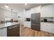 Kitchen featuring stainless steel appliances, granite counters, and white cabinets at 1986 Lake Ridge Blvd, Clearwater, FL 33763