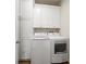 Laundry room featuring a modern washer, a dryer, and white cabinets at 1986 Lake Ridge Blvd, Clearwater, FL 33763
