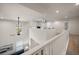 Bright loft view overlooking the downstairs living area with vaulted ceilings and large windows at 1986 Lake Ridge Blvd, Clearwater, FL 33763