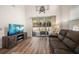 Living room featuring an entertainment center, reclining sofa, and glass sliding door to the outdoors at 1986 Lake Ridge Blvd, Clearwater, FL 33763