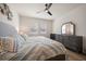 Bright main bedroom with two windows, ceiling fan, gray dresser, and hardwood style floors at 1986 Lake Ridge Blvd, Clearwater, FL 33763