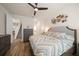 Beautiful main bedroom with hardwood floors, ceiling fan, and decorative wall art at 1986 Lake Ridge Blvd, Clearwater, FL 33763