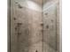 Walk in tiled shower features dual shower heads, corner shelves, and a glass enclosure at 1986 Lake Ridge Blvd, Clearwater, FL 33763