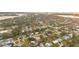 Aerial neighborhood view with vibrant green trees shows cozy homes, and the calming water beyond at 208 Palmetto W Rd, Nokomis, FL 34275