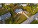 Spacious lot featuring a charming home with an open carport and well-manicured lawn, seen from above at 208 Palmetto W Rd, Nokomis, FL 34275