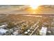 Wide aerial shot of a neighborhood, highlighting its proximity to the beach during sunset at 208 Palmetto W Rd, Nokomis, FL 34275
