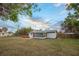 Backyard featuring a hot tub, screened porch, and a large grassy area at 208 Palmetto W Rd, Nokomis, FL 34275