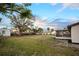 Wide angle shot of backyard with screened in porch and storage shed at 208 Palmetto W Rd, Nokomis, FL 34275