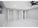 Basement features tile floors, ceiling fan, and multiple closets at 208 Palmetto W Rd, Nokomis, FL 34275