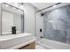 Stylish bathroom featuring modern vanity, and tub with beautiful tile at 208 Palmetto W Rd, Nokomis, FL 34275