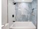Beautiful bath tub with blue marble tile surround and black fixtures at 208 Palmetto W Rd, Nokomis, FL 34275