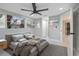 Bright, staged bedroom featuring a ceiling fan, a large window and hardwood-look floors at 208 Palmetto W Rd, Nokomis, FL 34275