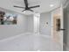Bright, empty bedroom with a ceiling fan, a large window and hardwood-look floors at 208 Palmetto W Rd, Nokomis, FL 34275
