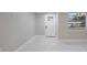 Bright, renovated living room with a modern door, window and marble floors, freshly painted in neutral tones at 208 Palmetto W Rd, Nokomis, FL 34275