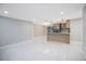 Spacious and modern open-concept living room and kitchen with white marble floors and neutral paint at 208 Palmetto W Rd, Nokomis, FL 34275