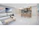 Open-concept living room and kitchen with modern finishes, sleek countertops, and stylish barstool seating at 208 Palmetto W Rd, Nokomis, FL 34275