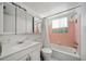 Bathroom with a white vanity, tile flooring, and a shower-tub combo with a shower curtain at 2113 Canal Dr # B2, Bradenton, FL 34207