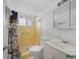 Bathroom features a tiled shower with curtain and tile floors at 2113 Canal Dr # B2, Bradenton, FL 34207