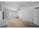 Bright bedroom featuring a ceiling fan, neutral carpet, and a large window at 2113 Canal Dr # B2, Bradenton, FL 34207