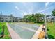 Spacious community shuffleboard court surrounded by benches and mature trees, providing a social outdoor setting at 2113 Canal Dr # B2, Bradenton, FL 34207