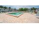 Sparkling community pool with lounge chairs and tables, ideal for relaxing and enjoying sunny days at 2113 Canal Dr # B2, Bradenton, FL 34207