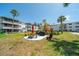 Community courtyard with picnic table, barbeque, and seating amidst lush tropical landscaping at 2113 Canal Dr # B2, Bradenton, FL 34207