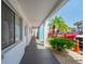 Exterior hallway with white walls and palm trees, and parking at 2113 Canal Dr # B2, Bradenton, FL 34207