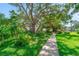 Beautiful walkway lined with mature trees and manicured landscaping enhancing the community's appeal at 2113 Canal Dr # B2, Bradenton, FL 34207
