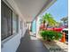 Exterior hallway with walkway and well-maintained landscaping with palm trees at 2113 Canal Dr # B2, Bradenton, FL 34207
