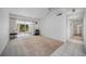 The living room has tile and carpet and sliding glass doors leading to a patio at 2113 Canal Dr # B2, Bradenton, FL 34207