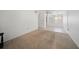 A bright and empty living room with tile flooring, neutral carpet, and a white ceiling at 2113 Canal Dr # B2, Bradenton, FL 34207