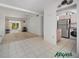 Open-concept living room featuring tile flooring, ceiling fan, and sliding glass doors to enclosed porch at 2113 Canal Dr # B2, Bradenton, FL 34207