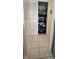 Organized pantry with shelving and bi-fold doors next to tiled kitchen floor at 2113 Canal Dr # B2, Bradenton, FL 34207