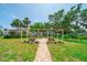 Outdoor picnic area with multiple tables, umbrellas, and lush landscaping providing a relaxing atmosphere at 2113 Canal Dr # B2, Bradenton, FL 34207