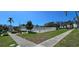 Community pool area features seating, manicured landscaping, and nearby resident parking at 2113 Canal Dr # B2, Bradenton, FL 34207