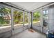 Sunroom enclosed by multiple windows, providing bright and airy space to enjoy the outdoors at 2113 Canal Dr # B2, Bradenton, FL 34207