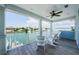 Charming balcony offering water views, a ceiling fan, and comfortable outdoor seating for enjoying the waterfront lifestyle at 2242 Donato Dr, Belleair Beach, FL 33786