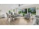 Cozy dining area featuring natural light, modern light fixture, hardwood floors, and stylish seating at 2251 Glenmoor N Rd, Clearwater, FL 33764