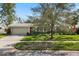 Charming single-story home with a manicured lawn and a cozy red front door at 2251 Glenmoor N Rd, Clearwater, FL 33764