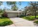 Well-maintained single-story home featuring a two-car garage and beautiful landscaping at 2251 Glenmoor N Rd, Clearwater, FL 33764