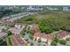 Aerial view of community featuring multiple townhomes with red tile roofs and lush landscaping at 236 Valencia Cir, St Petersburg, FL 33716