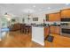 Open concept living with wood floors connecting the kitchen, dining, and living areas at 236 Valencia Cir, St Petersburg, FL 33716