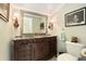 Elegant bathroom featuring a ornate vanity, beautiful lighting fixtures, and a toilet at 2506 Quincy S St, St Petersburg, FL 33711