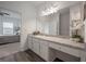 Bright bathroom with a long vanity, a decorative plant, and a view into the bedroom at 35392 Eastbrook Ave, Zephyrhills, FL 33541