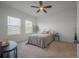 Bright bedroom with two windows, ceiling fan, and stylish gray bedding at 35392 Eastbrook Ave, Zephyrhills, FL 33541